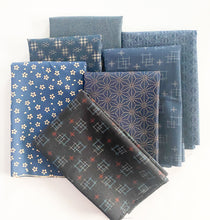Load image into Gallery viewer, Stack of geometric and ditsy floral prints on navy and indigo background in the Kasuri collection by Japanese designer Sevenberry for Robert Kaufman Fabrics.
