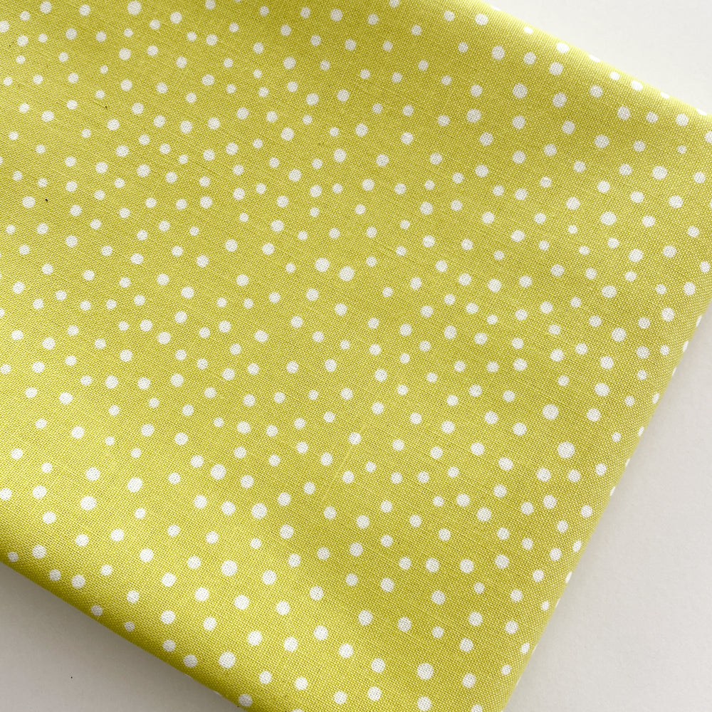 Close up of Happiest Dots in Mellow Lime from RJR Fabrics.  Happies Dots features organic white polka prints on a background of modern colors.