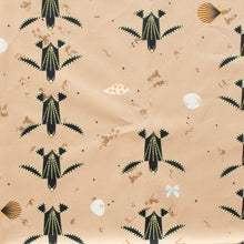 Load image into Gallery viewer, Turtles trek past a beach with shells printed on 100% GOT certified organic cotton poplin for Birch Fabrics.
