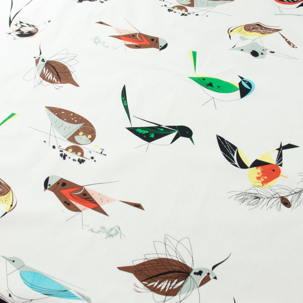 Flat layout of the main print from Charley Harper Western Birds collection at Global Fiber Shop. Birds and branches on a white organic cotton background.